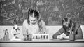 School chemistry lesson. School laboratory. Girl and boy smart students conduct school experiment. Describe chemical