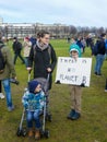 School child with family at anti climate change protest in The Hague with banners walking through the city