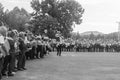 School child with gifts, flowers and balloons in their hands and the teacher at the holiday knowledge day, black and white photogr