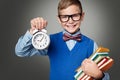 School Child in Glasses with Alarm Clock and Books, Smart Kid Royalty Free Stock Photo
