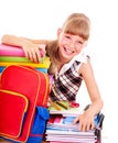 School child holding stack of books.