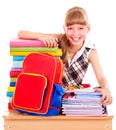 School child holding stack of books.