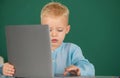 School child using digital pc laptop in class. Portrait of funny pupil of primary school study programming. Cute pupil Royalty Free Stock Photo