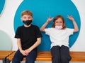 School children wearing face mask during corona virus and flu outbreak. Boy and girl going back to school after covid-19 Royalty Free Stock Photo