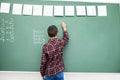 School child writing blackboard