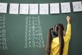 School child writing blackboard