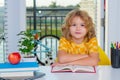 School child 7-8 years old with book go back to school. Child reading book. Little student doing homework at home. Royalty Free Stock Photo