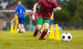 School children in Blue and Red Soccer Team in Training Slalom Drill. Kids Playing Football Ball on Grass Field Royalty Free Stock Photo