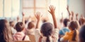 School children in classroom at lesson. Little children raising hands up and having fun in class. Royalty Free Stock Photo