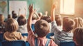 School children in classroom at lesson. Little children raising hands up and having fun in class. Royalty Free Stock Photo