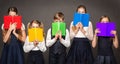 School Children Cover Face by Book. Kids Eyes Looking at Camera hiding by Rainbow Color Books. Group of Student Learning Reading Royalty Free Stock Photo