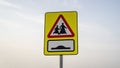 School children crossing sign in qatar along with speed bump sign on the road Royalty Free Stock Photo