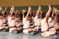 School children doing yoga with the teachers