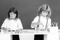 School children drawing a colorful pictures with pencil crayons in classroom on blackboard background. Portrait of cute Royalty Free Stock Photo