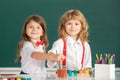 School children drawing a colorful pictures with pencil crayons in classroom. Portrait of cute pupils enjoying art and Royalty Free Stock Photo