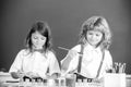 School children drawing a colorful pictures with pencil crayons in classroom. Portrait of cute pupils enjoying art and Royalty Free Stock Photo