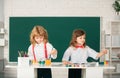 School children girl and boy painting with paints color and brush in classroom. Cute kids draw with colorful crayons. Royalty Free Stock Photo