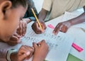 School, children and hands writing for teamwork with learning activity in classroom group together. Young kids and Royalty Free Stock Photo