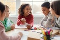 School children having fun using smartphone during break in classroom Royalty Free Stock Photo