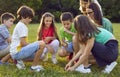 School children learning about nature and looking at plants through magnifying glass Royalty Free Stock Photo