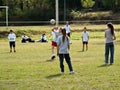 School children playing volleyball