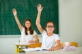 School children raised hands in class Royalty Free Stock Photo