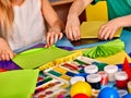 School children with scissors in kids hands cutting paper .