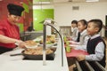 School children standing in line in school cafeteria