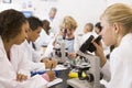 School children and their teacher in science class Royalty Free Stock Photo