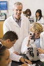 School children and their teacher in science class Royalty Free Stock Photo