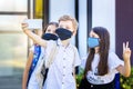 School children wearing protective face masks while taking selfie at school reopening