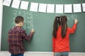 School children writing blackboard