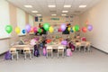 School class on September 1st without students with colorful balloons, school bags, textbooks and flowers on desks. Overal plan Royalty Free Stock Photo