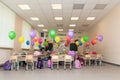 School class on September 1st without students with colorful balloons, school bags, textbooks and flowers on desks. Overal plan Royalty Free Stock Photo