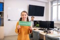 Girl holding green sign with word knowledgeable