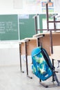 School classroom with school desks and blackboard .