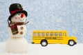 School Closings with happy snowman with hat, school bus, and snow Royalty Free Stock Photo