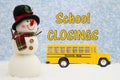 School Closings message with happy snowman with hat, school bus, and snow Royalty Free Stock Photo