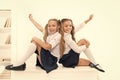 School club. Little schoolgirls classmates friendly kids. Schoolgirls friends sit on desk. Best friends relaxing Royalty Free Stock Photo