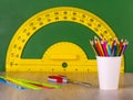 School concept colore pencil, ruler, scissors and yellow protractor
