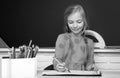 School concept. Kid writing on textbook. Little student doing homework at elementary school. Little girl pupil study in Royalty Free Stock Photo