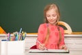 School concept. Kid writing on textbook. Little student doing homework at elementary school. Little girl pupil study in Royalty Free Stock Photo