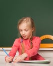 School concept. Kids drawing in notepad. Little girl pupil study in classroom. School student taking notes from book for Royalty Free Stock Photo