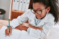 School is cool and thats a fact. an adorable young school girl drawing a diagram in her exercise book in science class