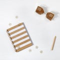 School copybook with metal clips. Closed notebook on spring, hourglass and wooden pencil