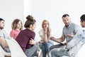 School counselor explaining anger management techniques to a group of teenagers