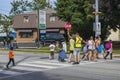 School crossing guard helps children to cross the street.