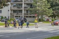 School crossing guard helps children to cross the street.