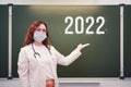 School doctor shows on the blackboard with the inscription 2022