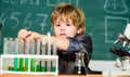 School education. Boy use microscope and test tubes in school classroom. Chemical analysis. Toddler genius baby. Science